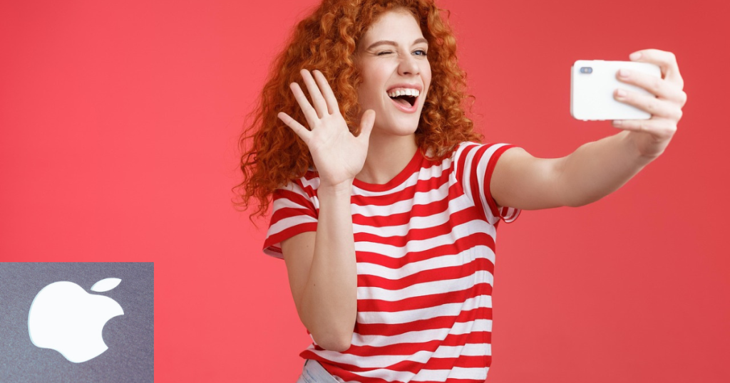 jovem ruiva usando Iphone para tirar selfie